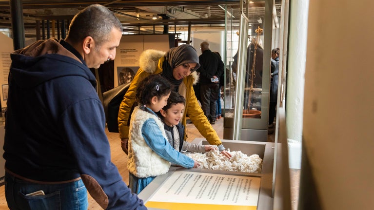 Visitors exploring the exhibition gallery at Quarry Bank Mill, Cheshire